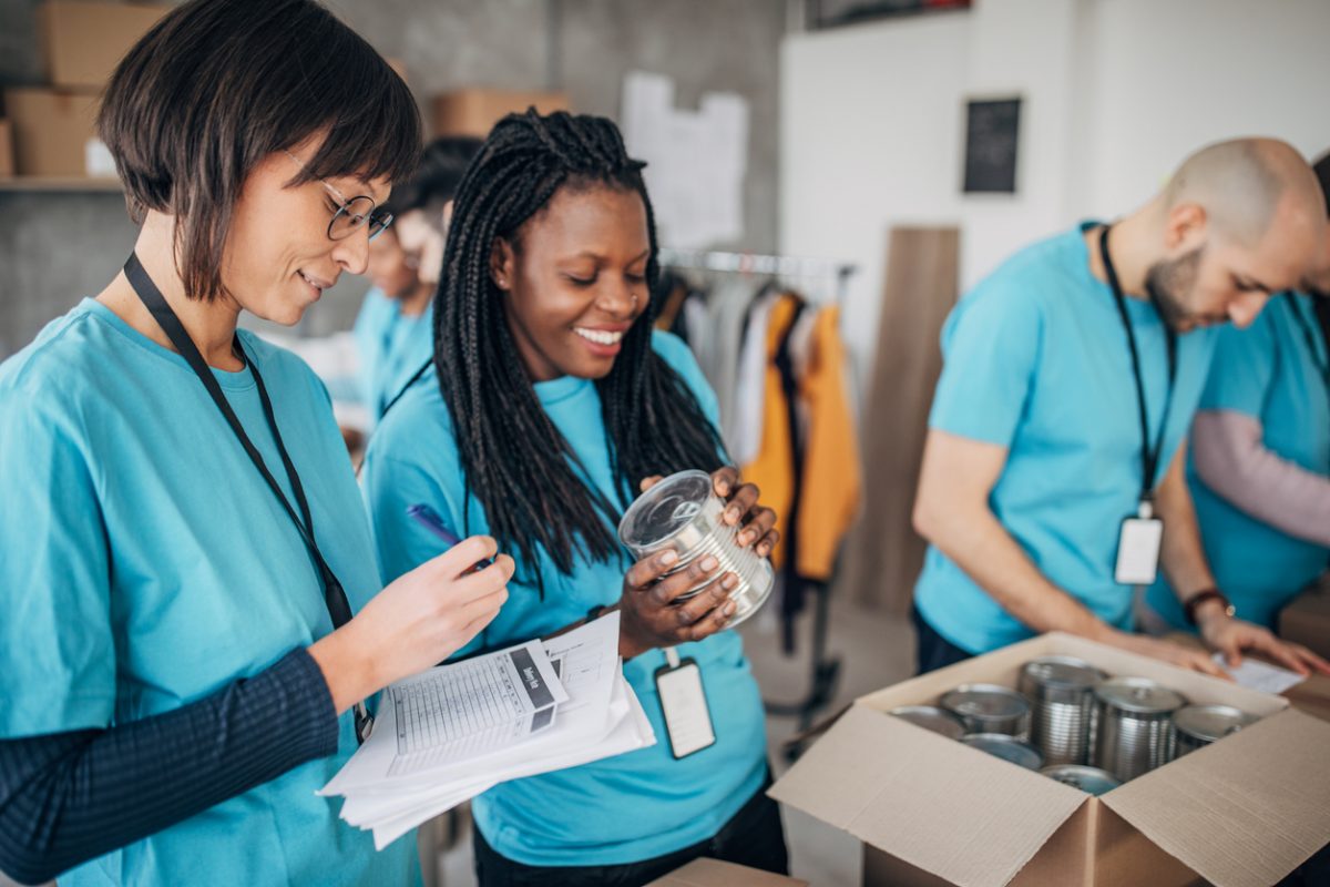 volunteers packing donation boxes in charity food bank